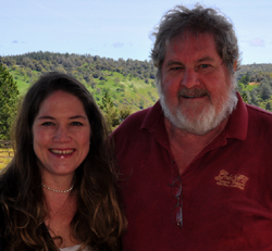 Two people standing together outdoors at the vineyard
